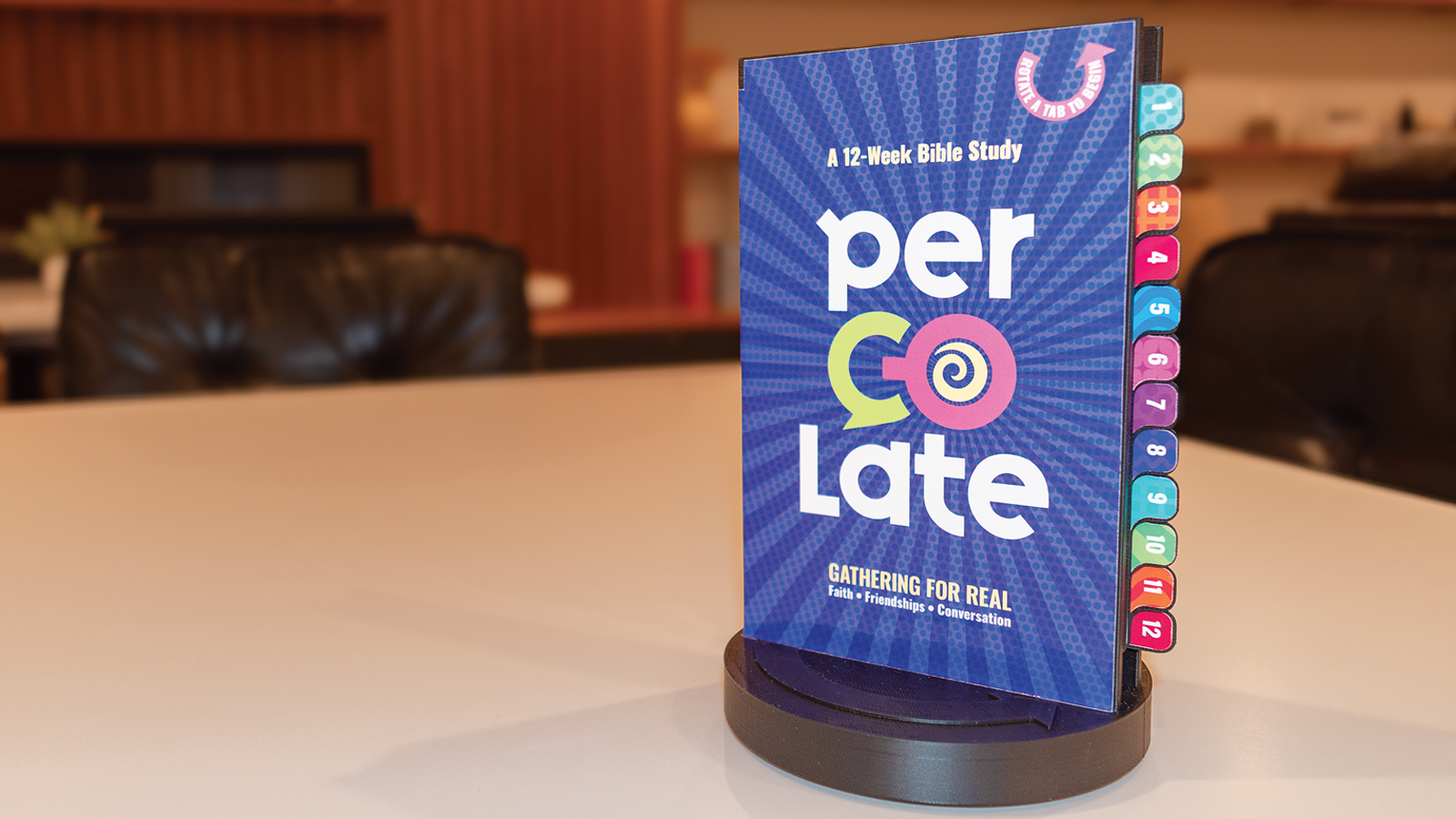 Percolate 12-week Bible study system on a swivel stand in a coffee shop setting