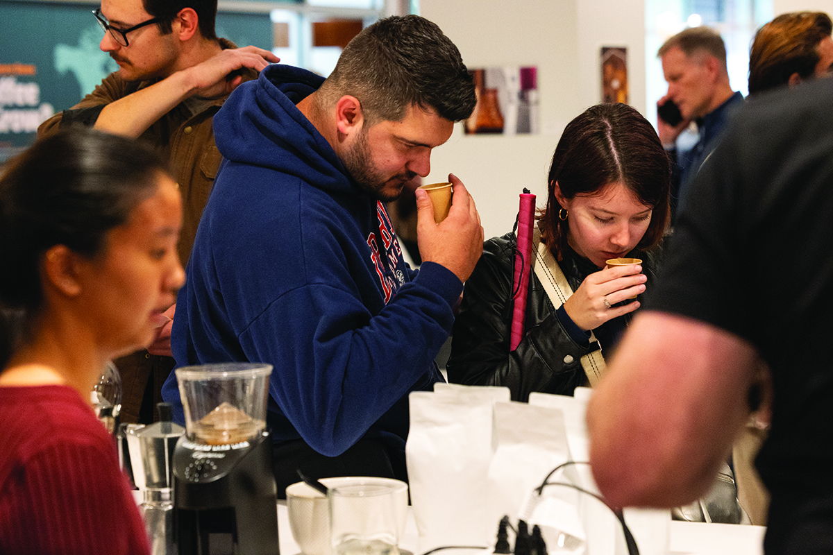 Students engaging with coffee brewing demonstrations at the Brewseum event in the LU One lounge at Liberty University
